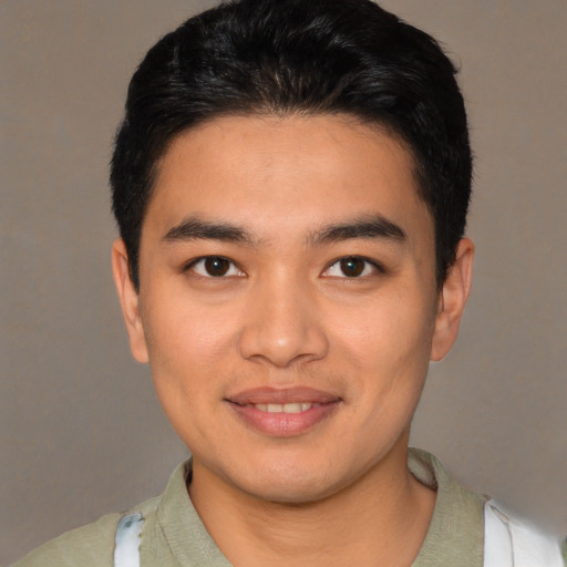 Joyful latino young-adult male with short  brown hair and brown eyes