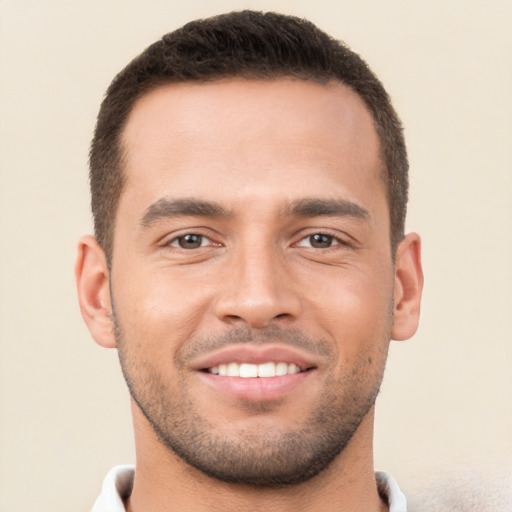 Joyful white young-adult male with short  brown hair and brown eyes