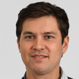 Joyful white young-adult male with short  brown hair and brown eyes