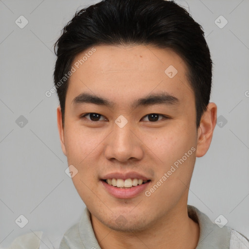 Joyful asian young-adult male with short  brown hair and brown eyes