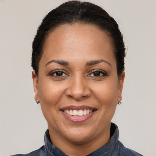 Joyful latino young-adult female with short  brown hair and brown eyes