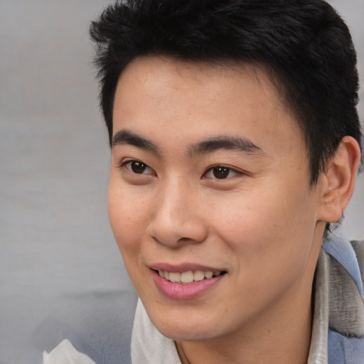 Joyful asian young-adult male with short  brown hair and brown eyes