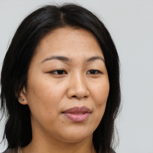 Joyful asian adult female with long  brown hair and brown eyes