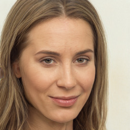 Joyful white adult female with long  brown hair and brown eyes