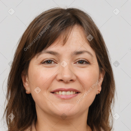 Joyful white adult female with medium  brown hair and brown eyes