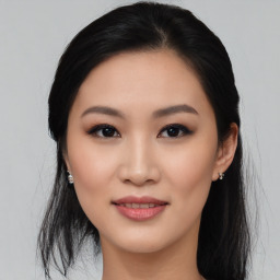 Joyful asian young-adult female with medium  black hair and brown eyes