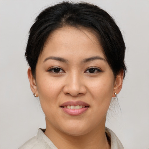 Joyful asian young-adult female with short  brown hair and brown eyes