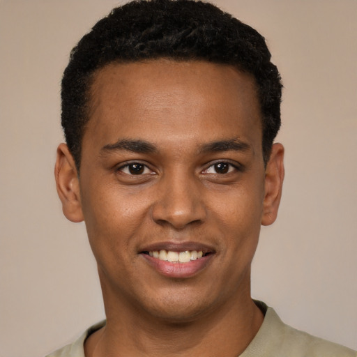 Joyful black young-adult male with short  black hair and brown eyes