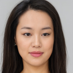 Joyful asian young-adult female with long  brown hair and brown eyes