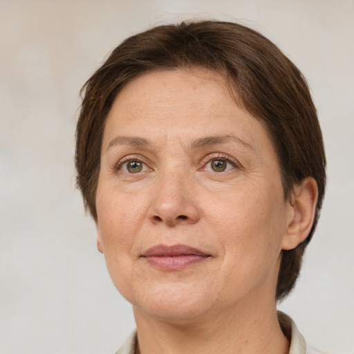 Joyful white adult female with short  brown hair and grey eyes