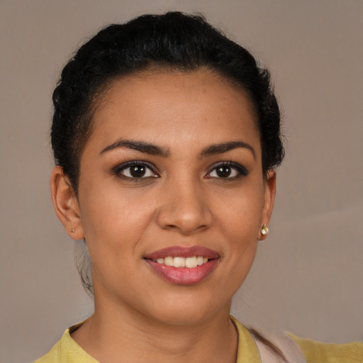Joyful latino young-adult female with short  brown hair and brown eyes