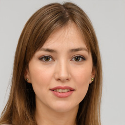 Joyful white young-adult female with long  brown hair and green eyes