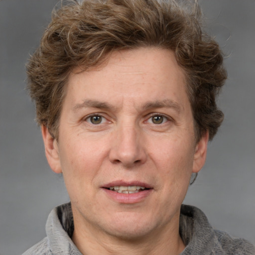 Joyful white adult male with short  brown hair and grey eyes