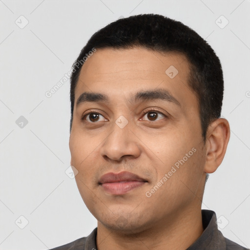 Joyful latino young-adult male with short  black hair and brown eyes