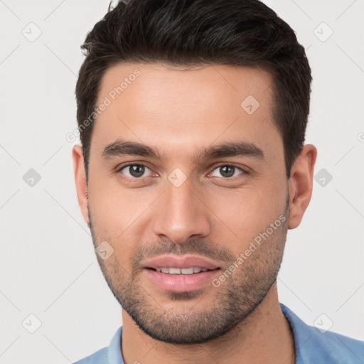 Joyful white young-adult male with short  brown hair and brown eyes