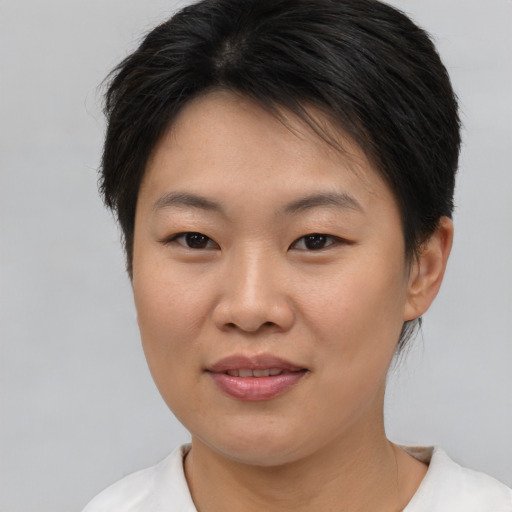 Joyful asian young-adult female with short  brown hair and brown eyes