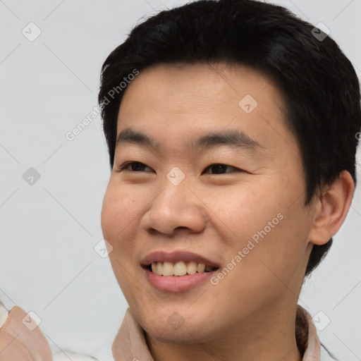 Joyful asian young-adult male with short  black hair and brown eyes