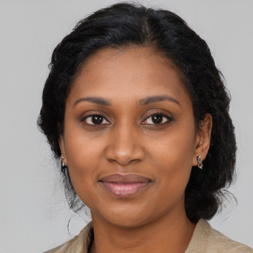 Joyful black young-adult female with medium  brown hair and brown eyes