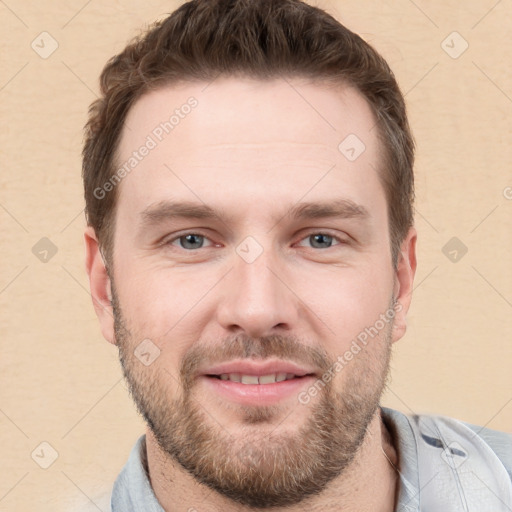 Joyful white young-adult male with short  brown hair and grey eyes