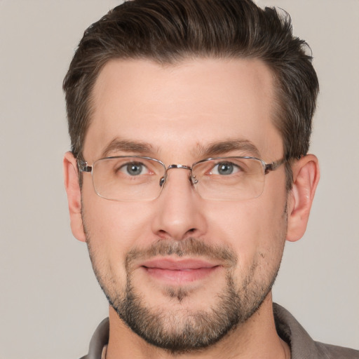 Joyful white adult male with short  brown hair and brown eyes