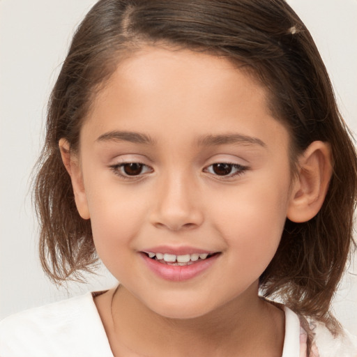 Joyful white child female with medium  brown hair and brown eyes