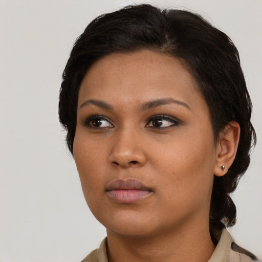 Neutral black young-adult female with medium  black hair and brown eyes