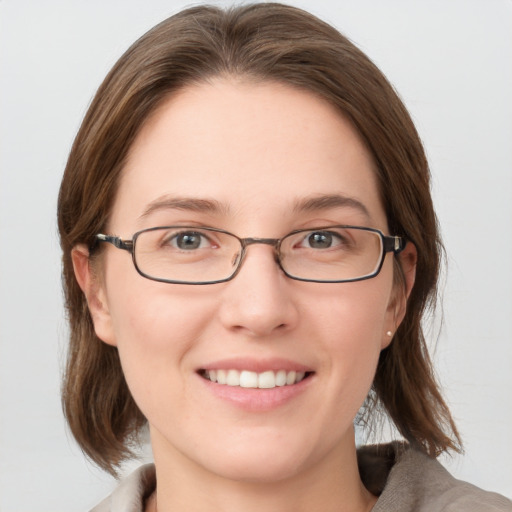 Joyful white young-adult female with medium  brown hair and blue eyes