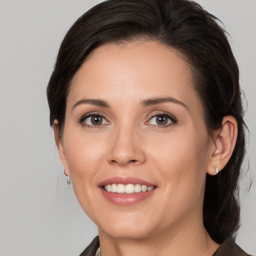 Joyful white young-adult female with medium  brown hair and brown eyes