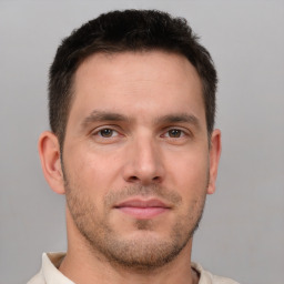 Joyful white young-adult male with short  brown hair and brown eyes