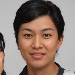 Joyful asian young-adult female with medium  black hair and brown eyes