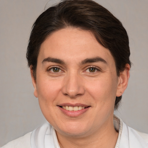 Joyful white adult female with medium  brown hair and brown eyes