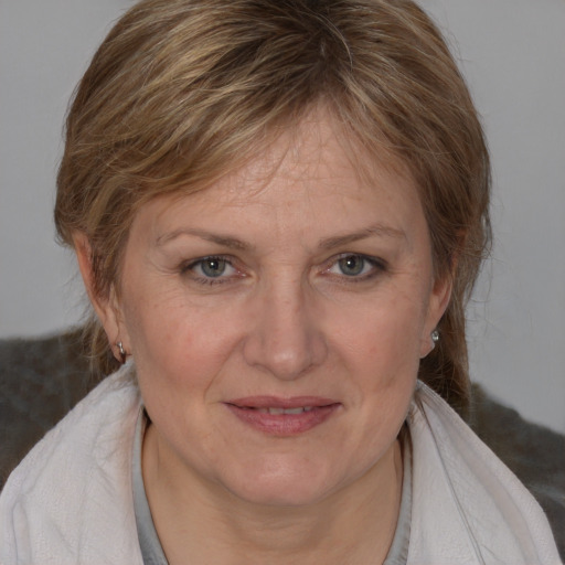 Joyful white adult female with medium  brown hair and grey eyes