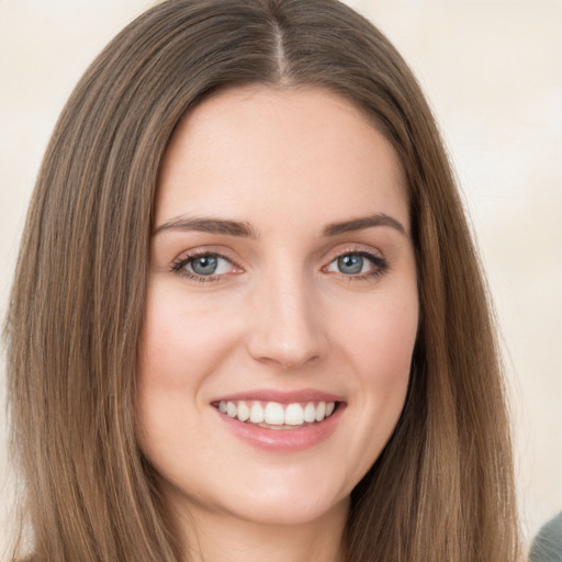 Joyful white young-adult female with long  brown hair and green eyes