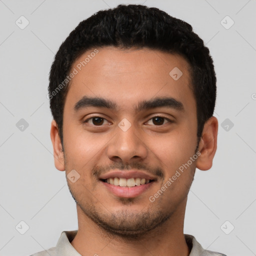 Joyful latino young-adult male with short  black hair and brown eyes