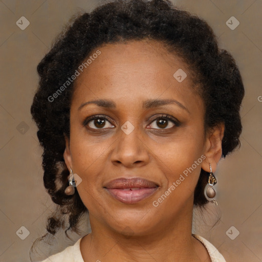 Joyful black adult female with medium  brown hair and brown eyes