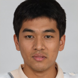 Joyful asian young-adult male with short  black hair and brown eyes