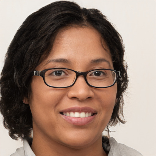 Joyful white adult female with medium  brown hair and brown eyes