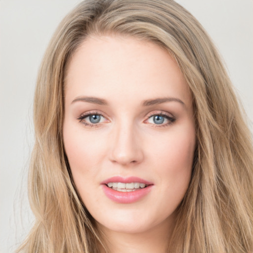 Joyful white young-adult female with long  brown hair and blue eyes