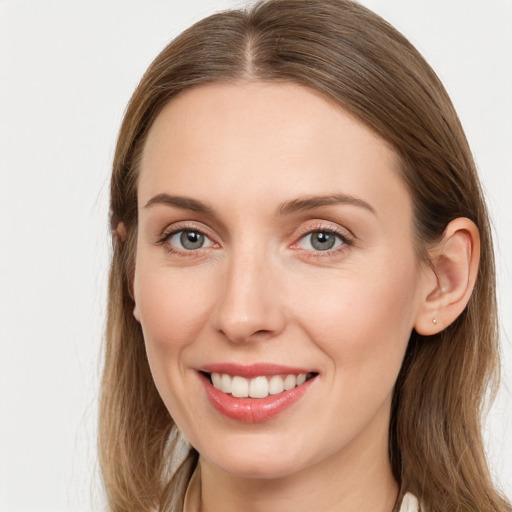 Joyful white young-adult female with long  brown hair and grey eyes