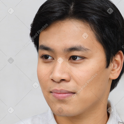 Joyful asian young-adult male with short  black hair and brown eyes