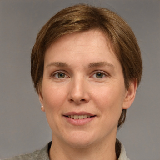 Joyful white adult female with short  brown hair and grey eyes