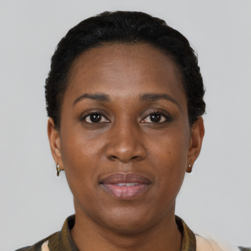 Joyful black adult female with short  brown hair and brown eyes