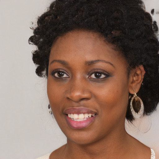 Joyful black young-adult female with medium  black hair and brown eyes