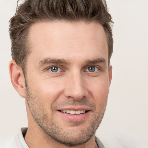 Joyful white young-adult male with short  brown hair and brown eyes