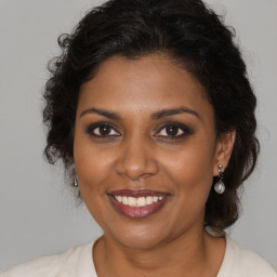 Joyful black young-adult female with medium  brown hair and brown eyes