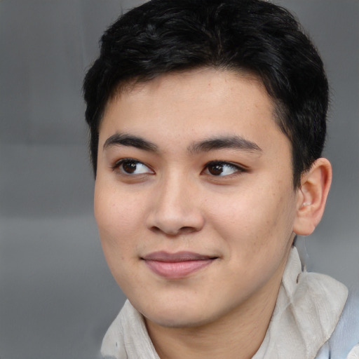 Joyful asian young-adult male with short  brown hair and brown eyes