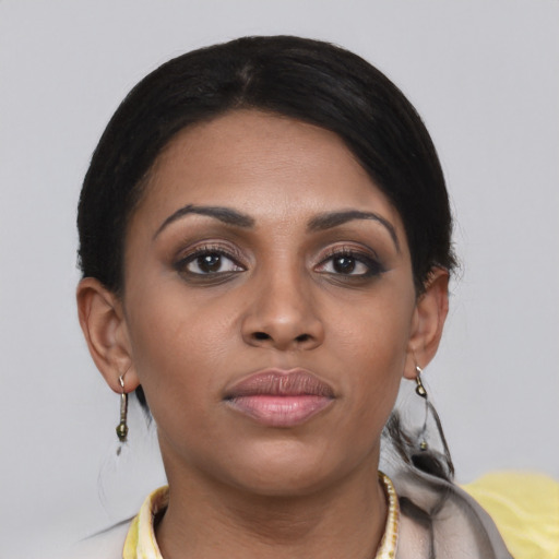 Joyful asian young-adult female with short  black hair and brown eyes