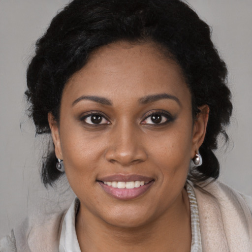 Joyful black young-adult female with medium  brown hair and brown eyes