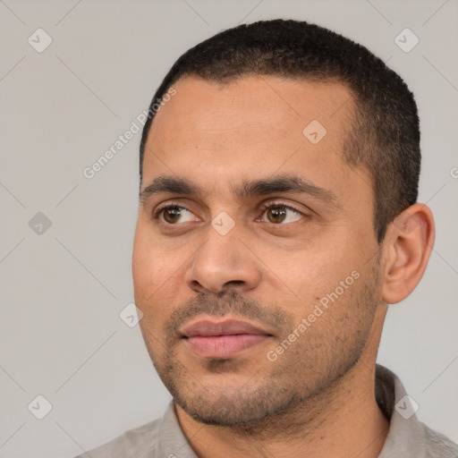 Joyful latino young-adult male with short  black hair and brown eyes