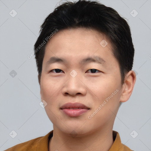 Joyful asian young-adult male with short  brown hair and brown eyes